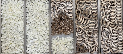 mushrooms and sweet onions on trays to go into freeze dryer